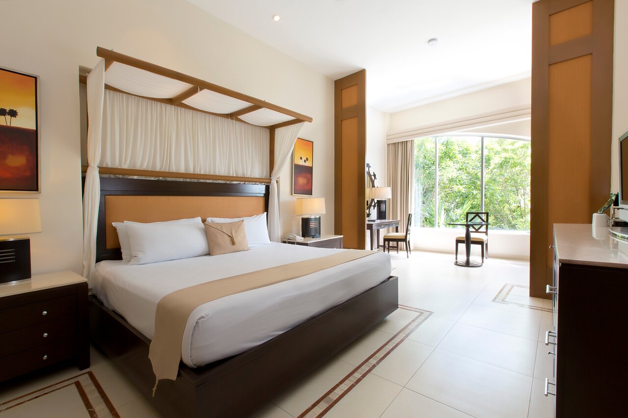 Junior Suite Garden View. All suites feature: Tropical garden views, furnished balcony, flat screen, hair dryer, security box, telephone, ironing set, air conditioning, alarm clock radio, double Jacuzzi either on balcony or in room, stocked mini bar, bathrobes for use during stay, slippers.