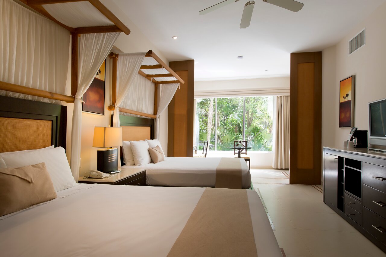 All suites feature: Tropical garden views, furnished balcony, flat screen, hair dryer, security box, telephone, ironing set, air conditioning, alarm clock radio, double Jacuzzi either on balcony or in room, stocked mini bar, bathrobes for use during stay, slippers.