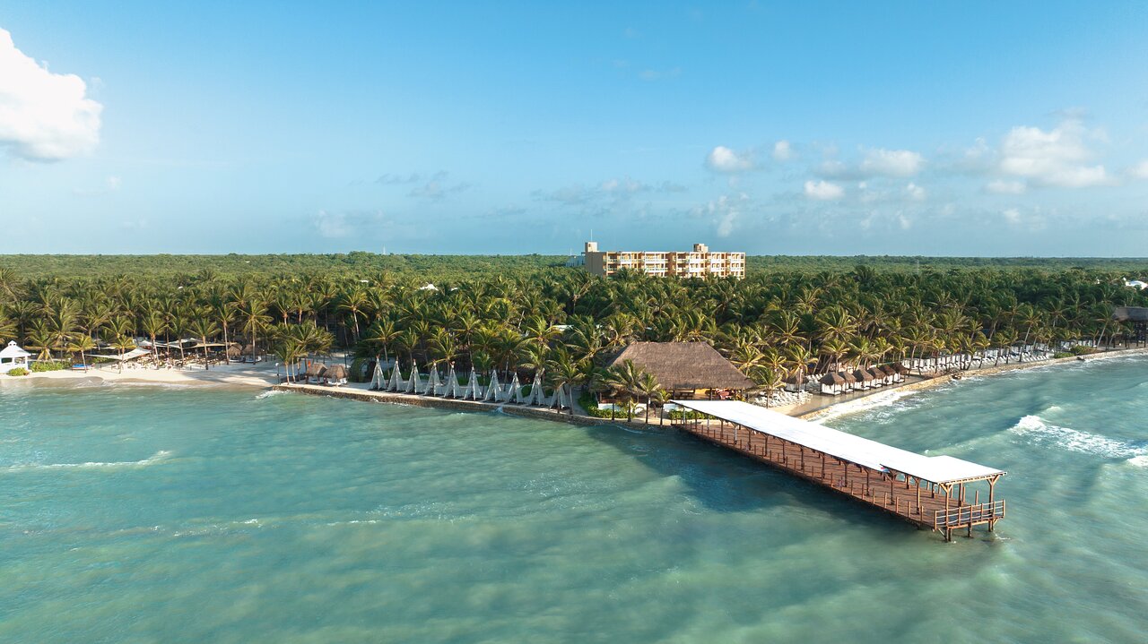 Vista del área principal de El Dorado Seaside Palms en Riviera Maya, rodeado de palmeras y ambiente tropical.